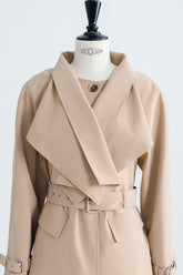Tailored wool blend trench coat with oversized lapels and structured belted waist
